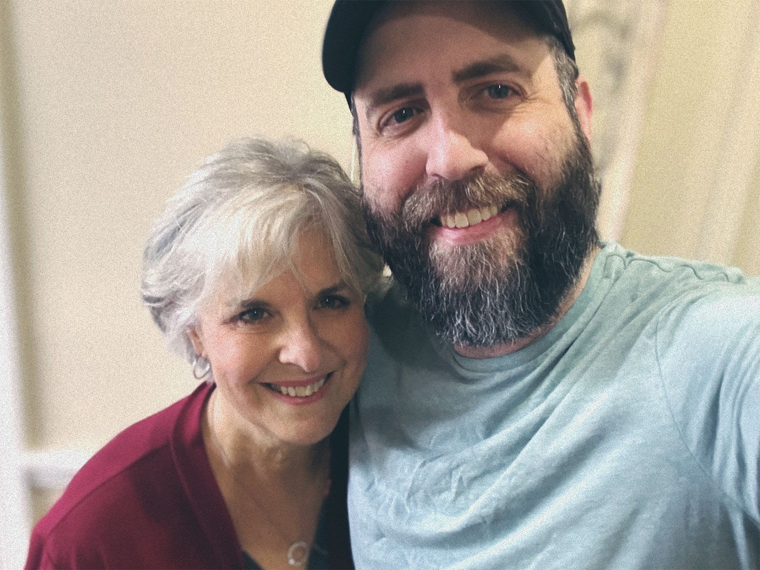 Josh and his mom, smiling, at home.